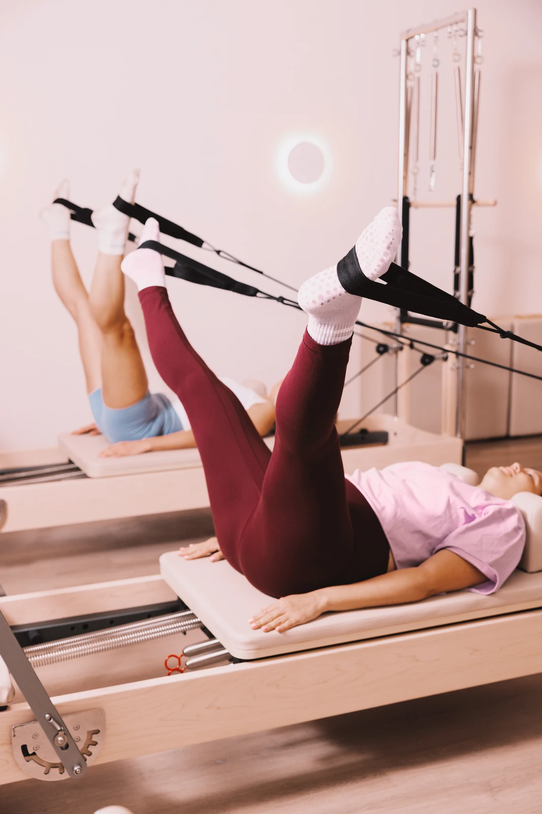 Students practising with Reformer straps at Soma Co.
