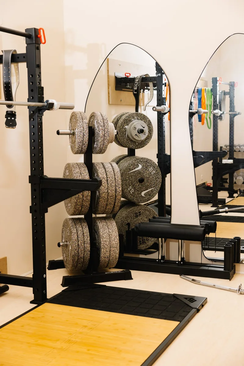A rack and weight plates in the Strength Lab